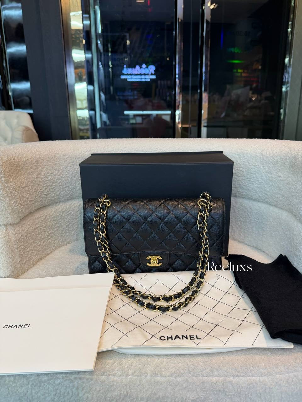 Chanel Classic Flap Bag in Black Caviar leather with gold-tone hardware