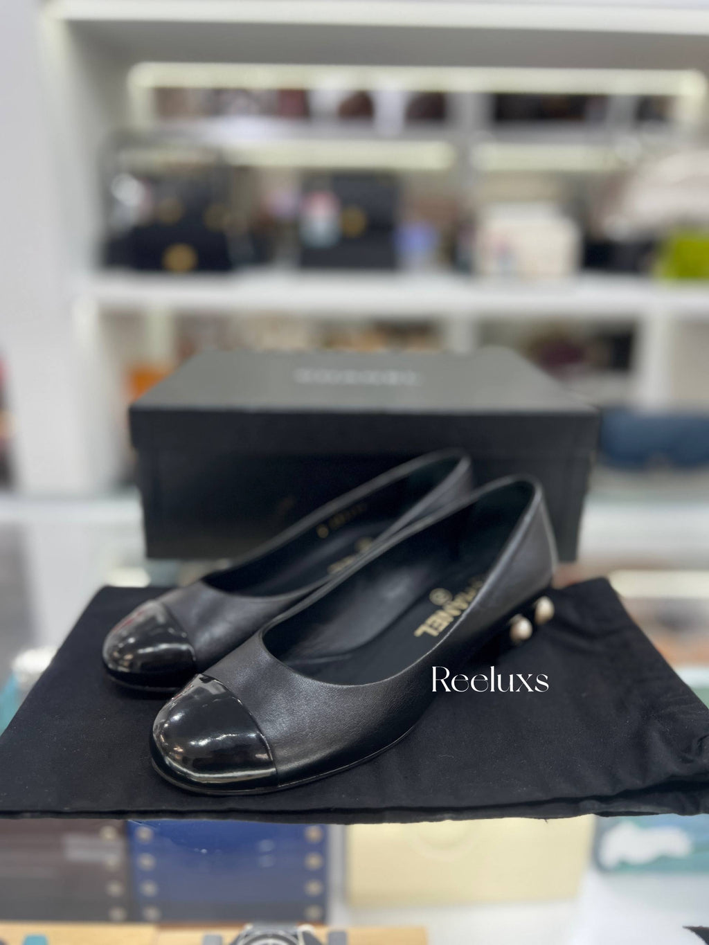 CHANEL Black Leather Cap-Toe Flats With Pearl-Embellished Heel