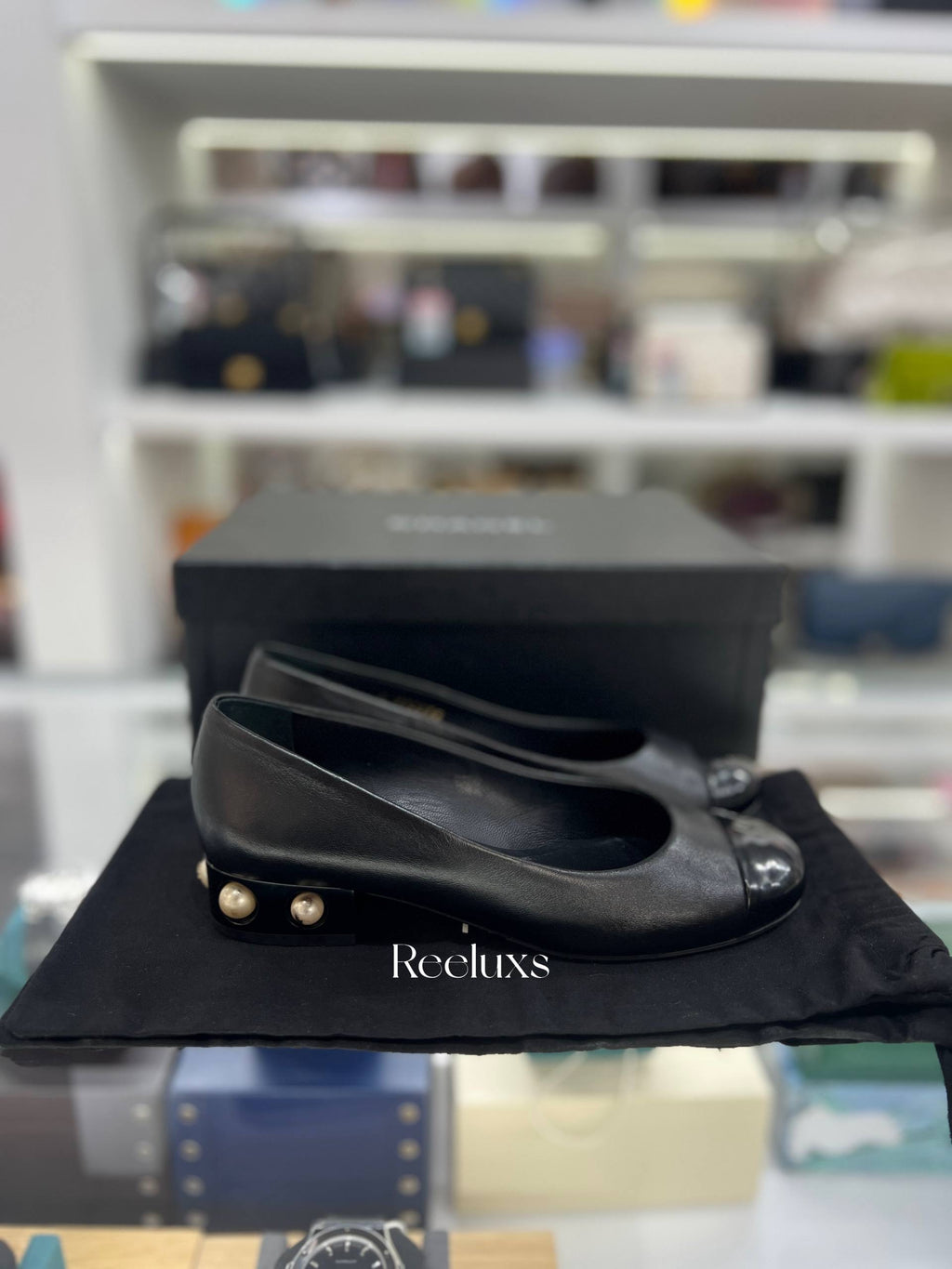 CHANEL Black Leather Cap-Toe Flats With Pearl-Embellished Heel