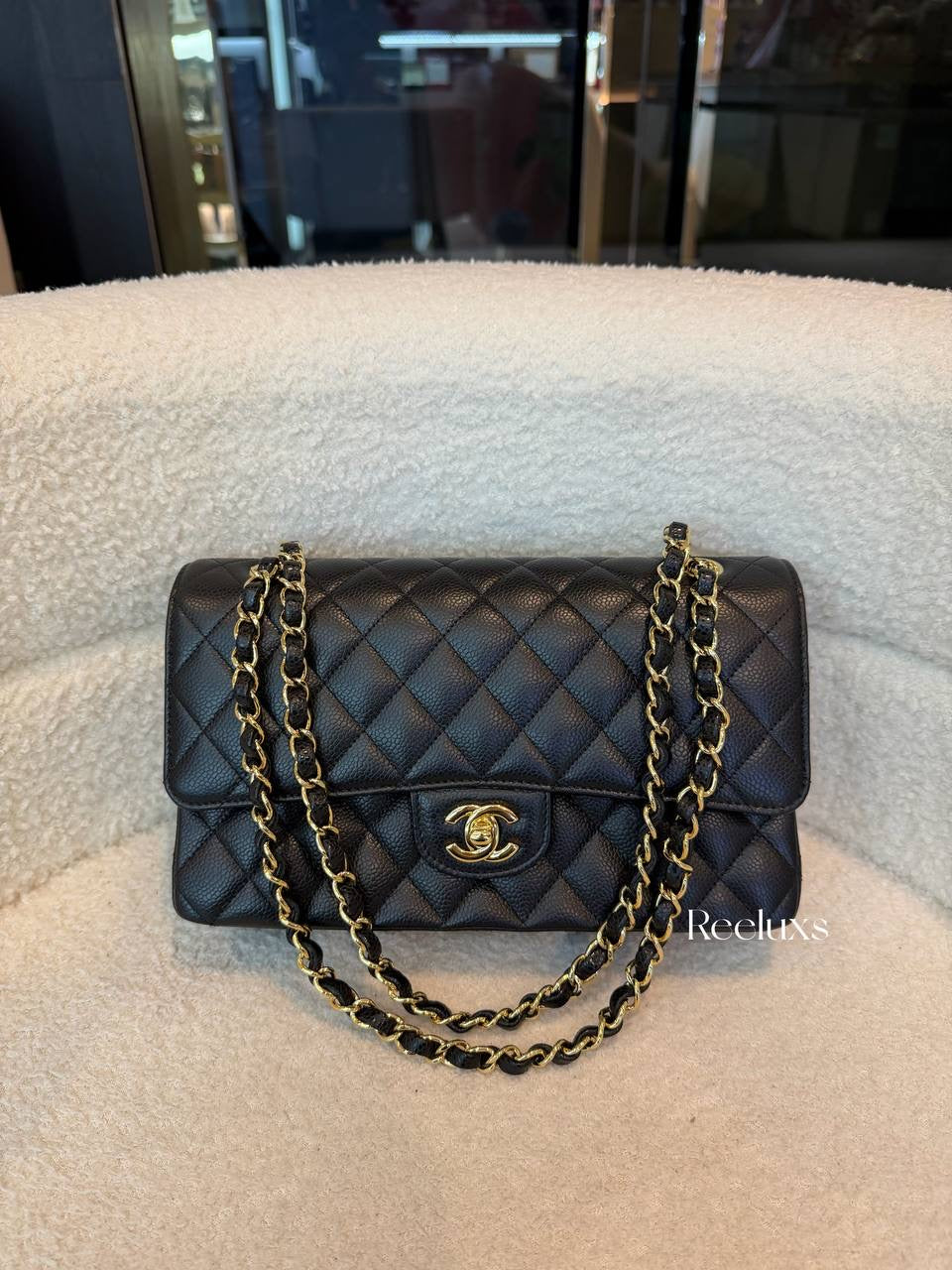 Chanel Classic Flap Bag in Black Caviar leather with gold-tone hardware