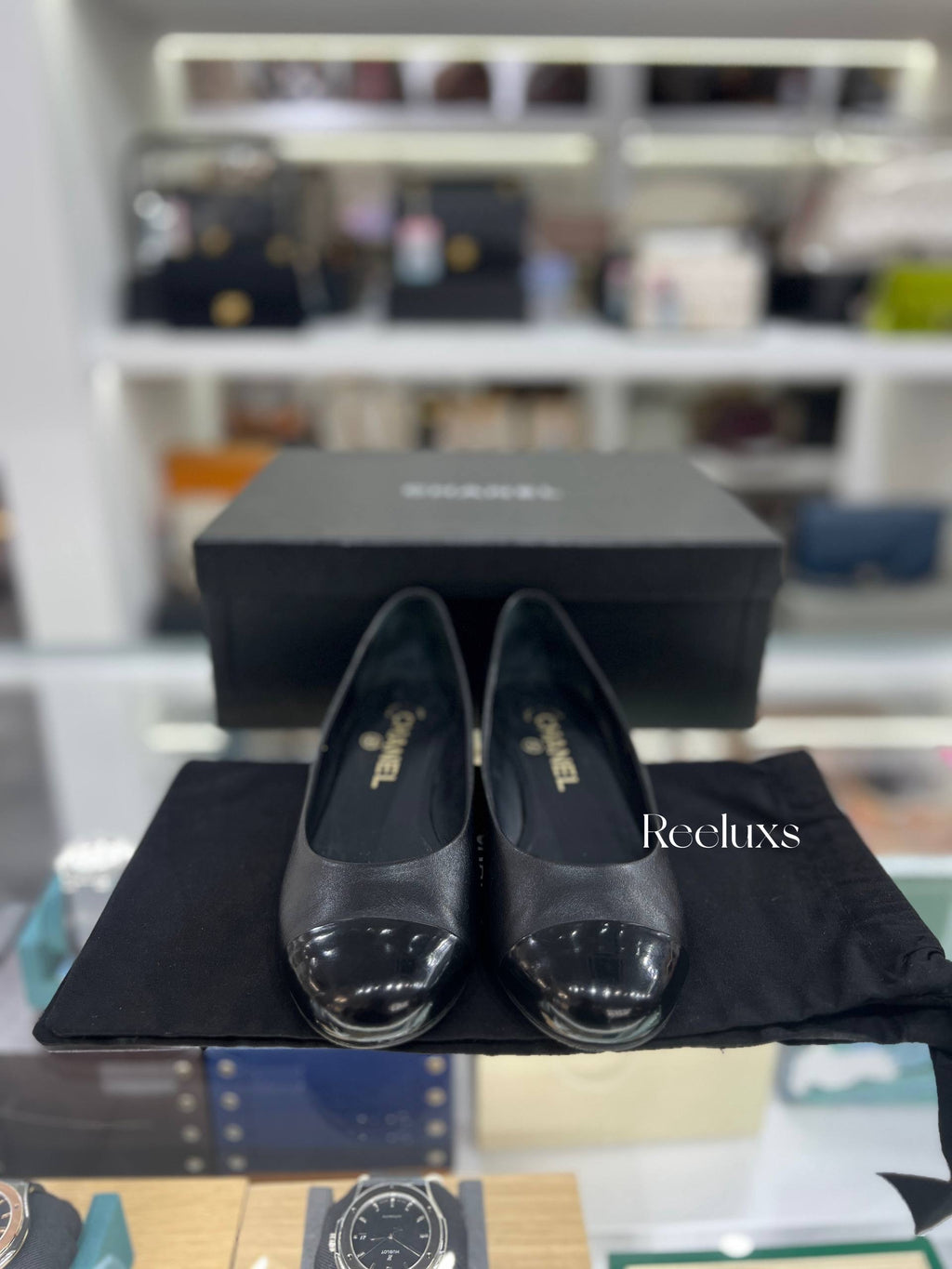 CHANEL Black Leather Cap-Toe Flats With Pearl-Embellished Heel