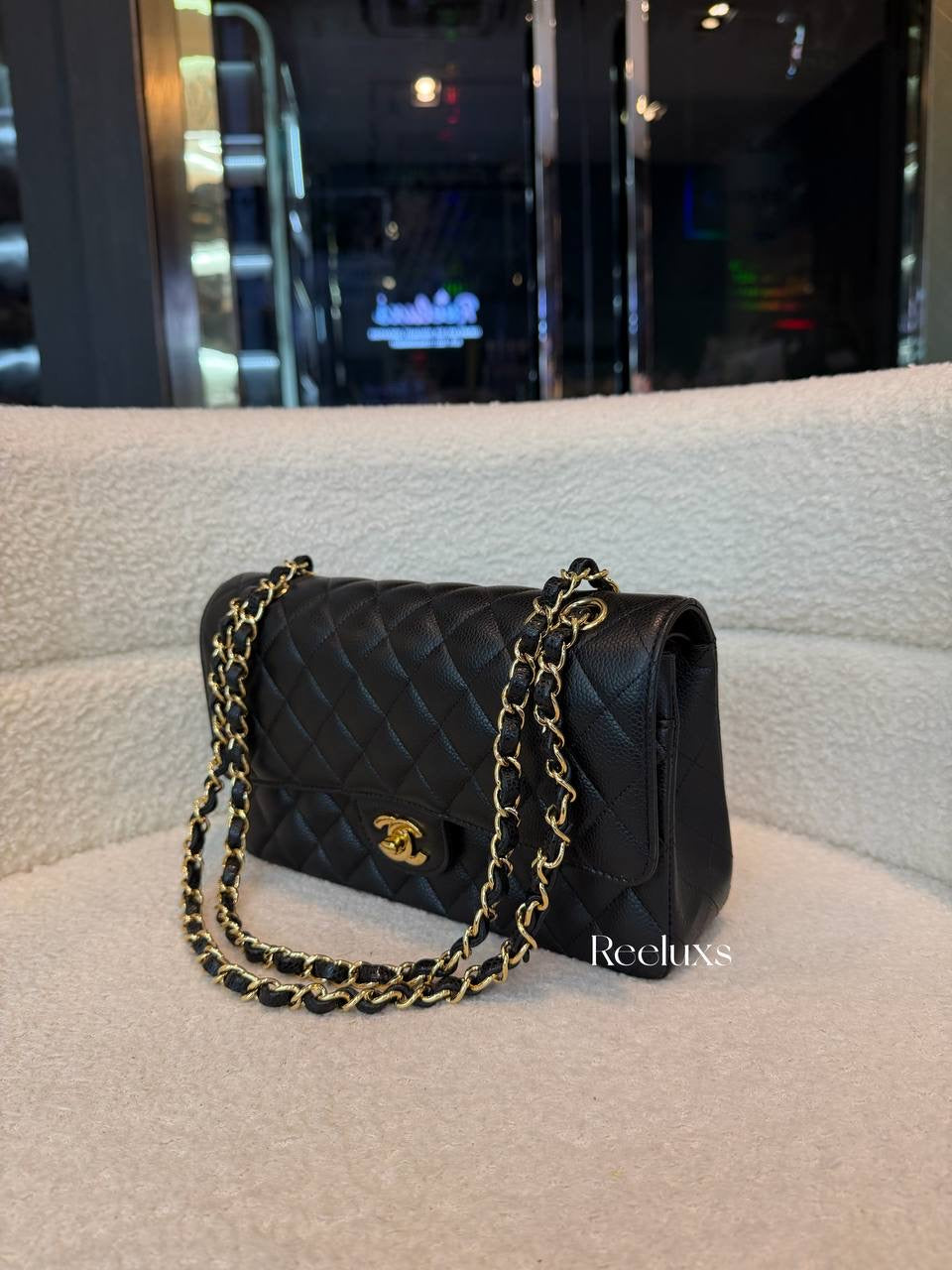 Chanel Classic Flap Bag in Black Caviar leather with gold-tone hardware