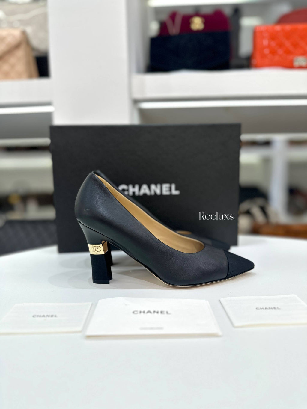 CHANEL Black Leather and Grosgrain Cap-Toe Pumps