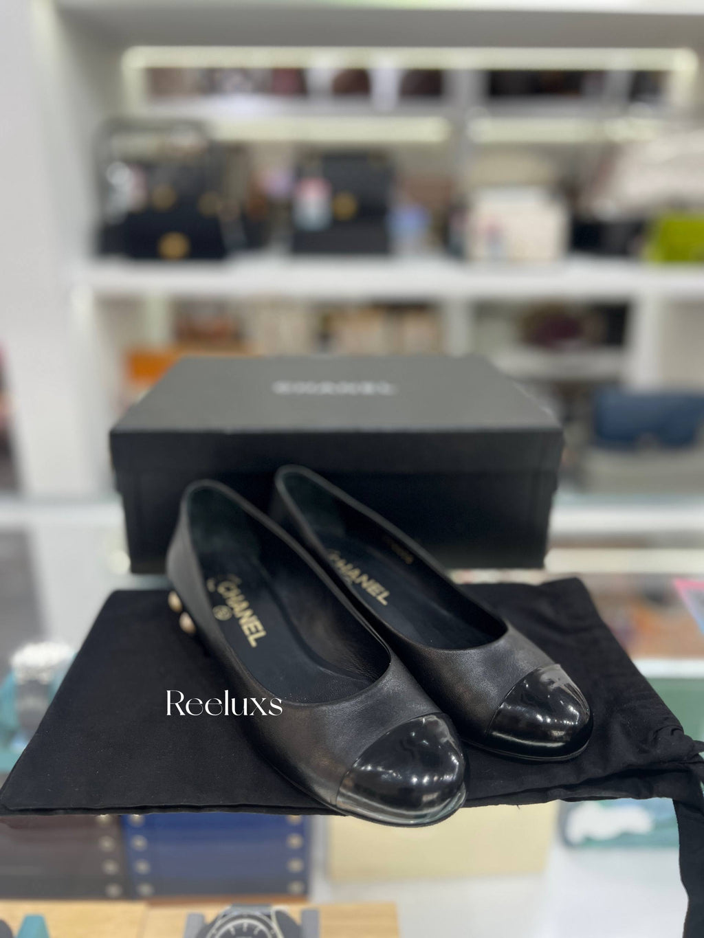 CHANEL Black Leather Cap-Toe Flats With Pearl-Embellished Heel