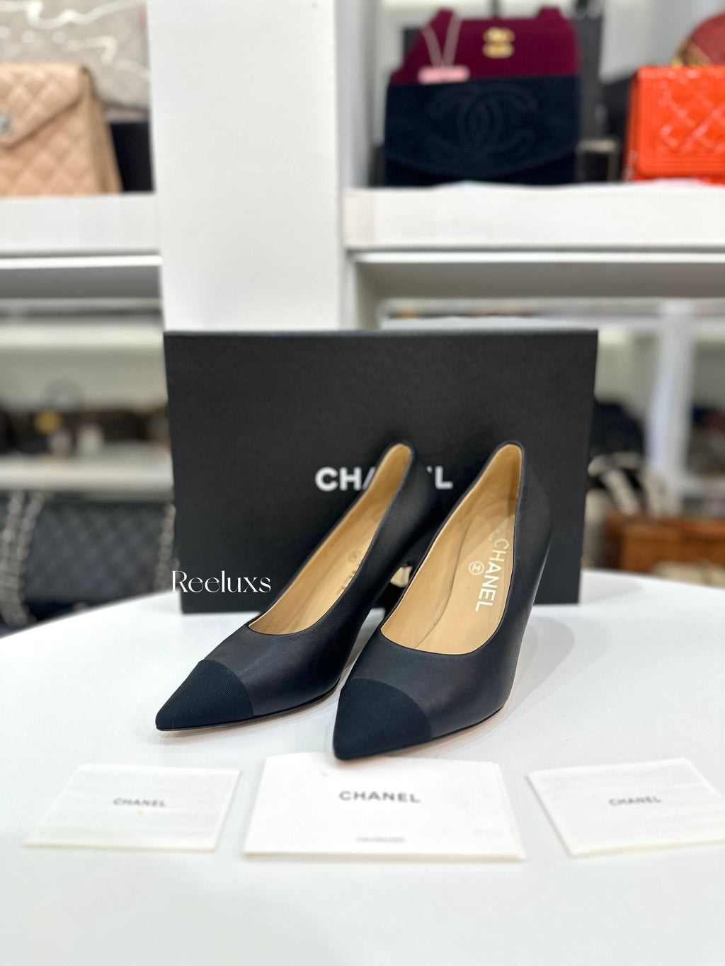 CHANEL Black Leather and Grosgrain Cap-Toe Pumps