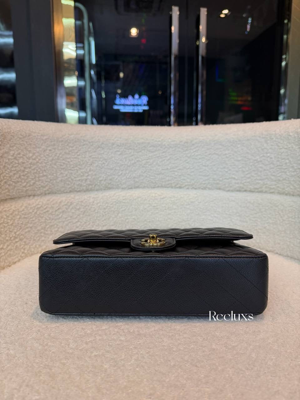 Chanel Classic Flap Bag in Black Caviar leather with gold-tone hardware