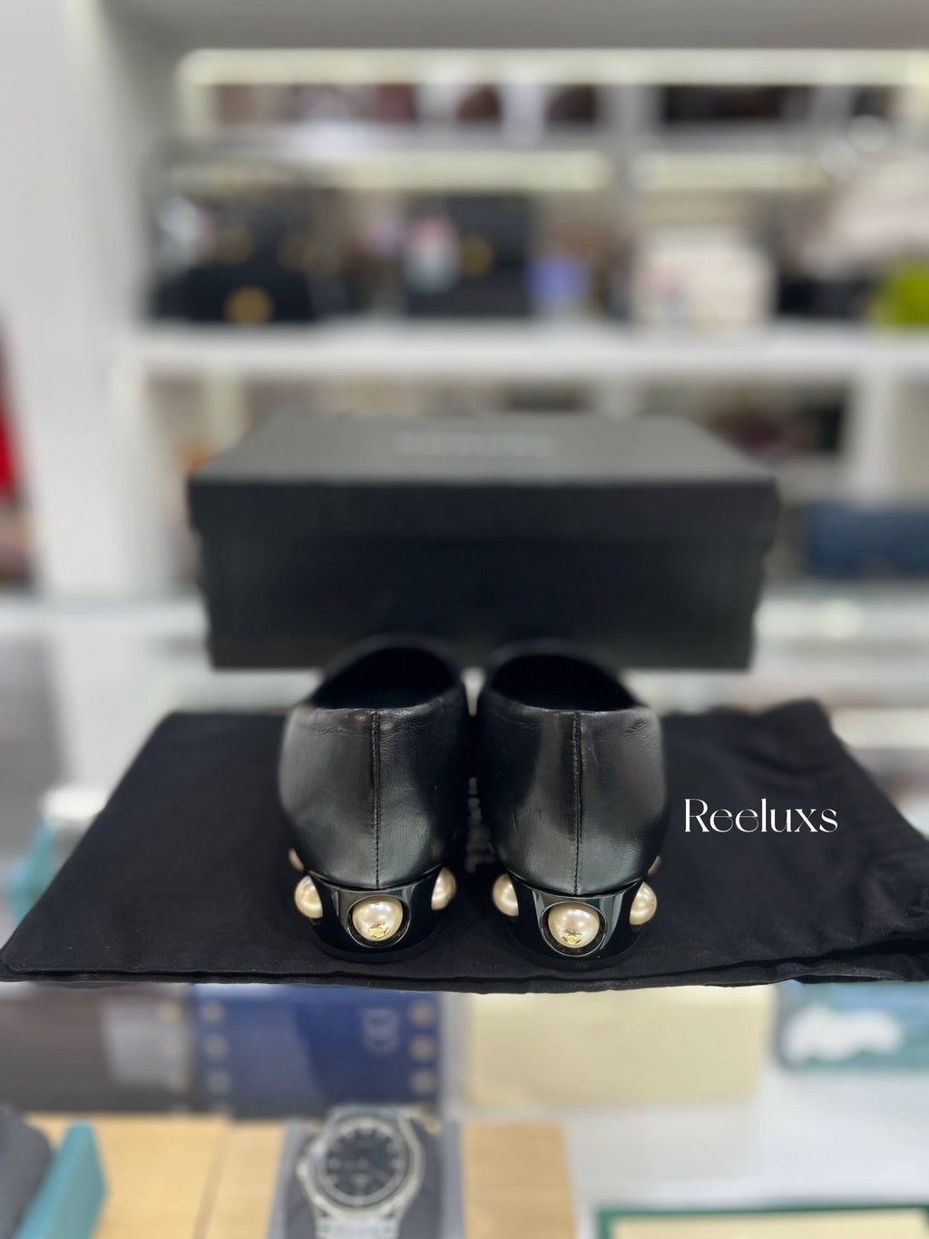 CHANEL Black Leather Cap-Toe Flats With Pearl-Embellished Heel