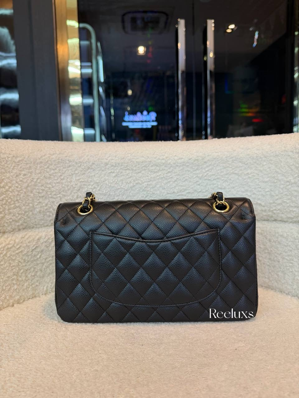 Chanel Classic Flap Bag in Black Caviar leather with gold-tone hardware